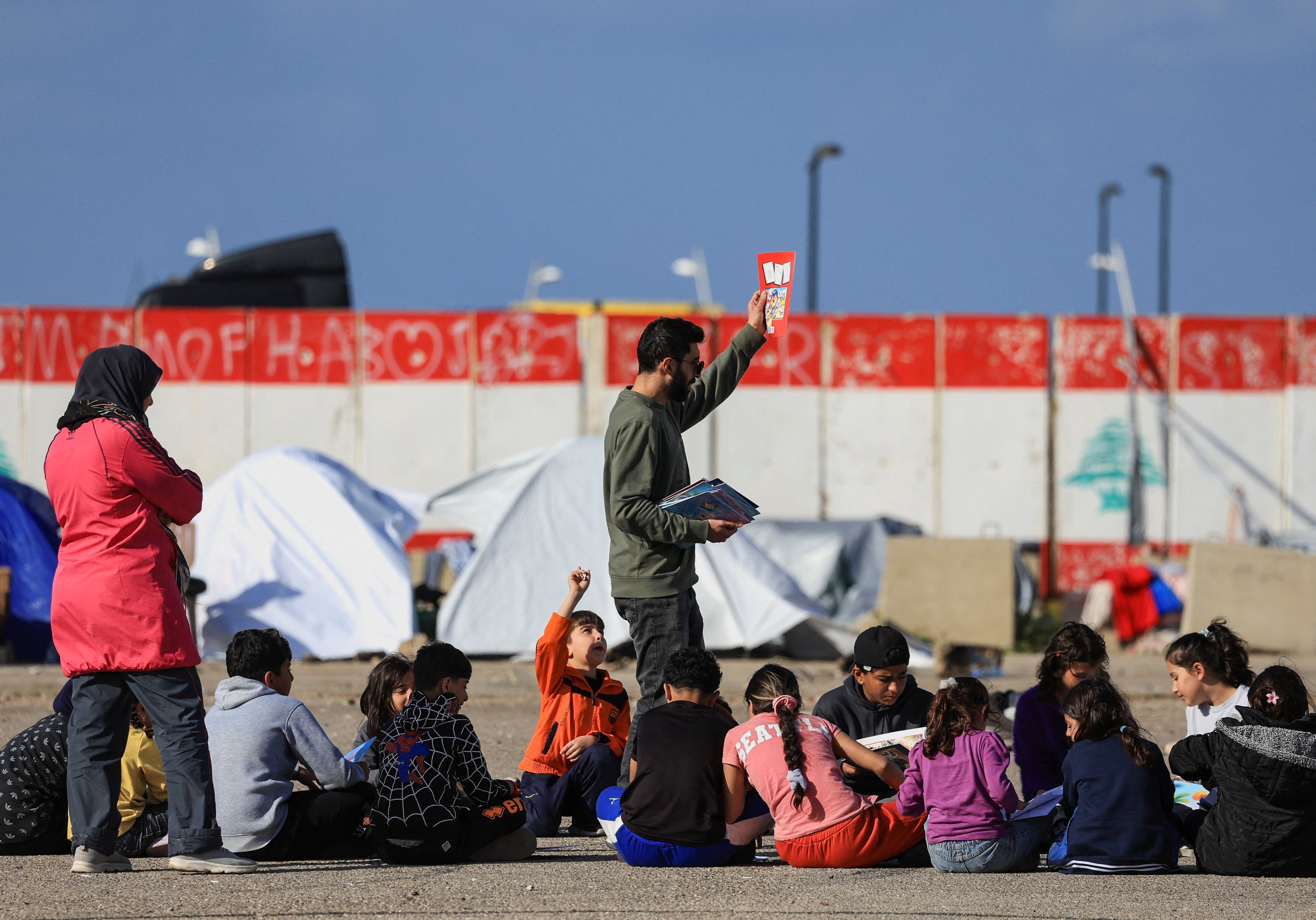 Hossan, a volunteer, organizes activities and games for displaced children, following an escalation between Hezbollah and Israel, amid the US-Israeli conflict with Iran, in Beirut, Lebanon, March 16, 2026.