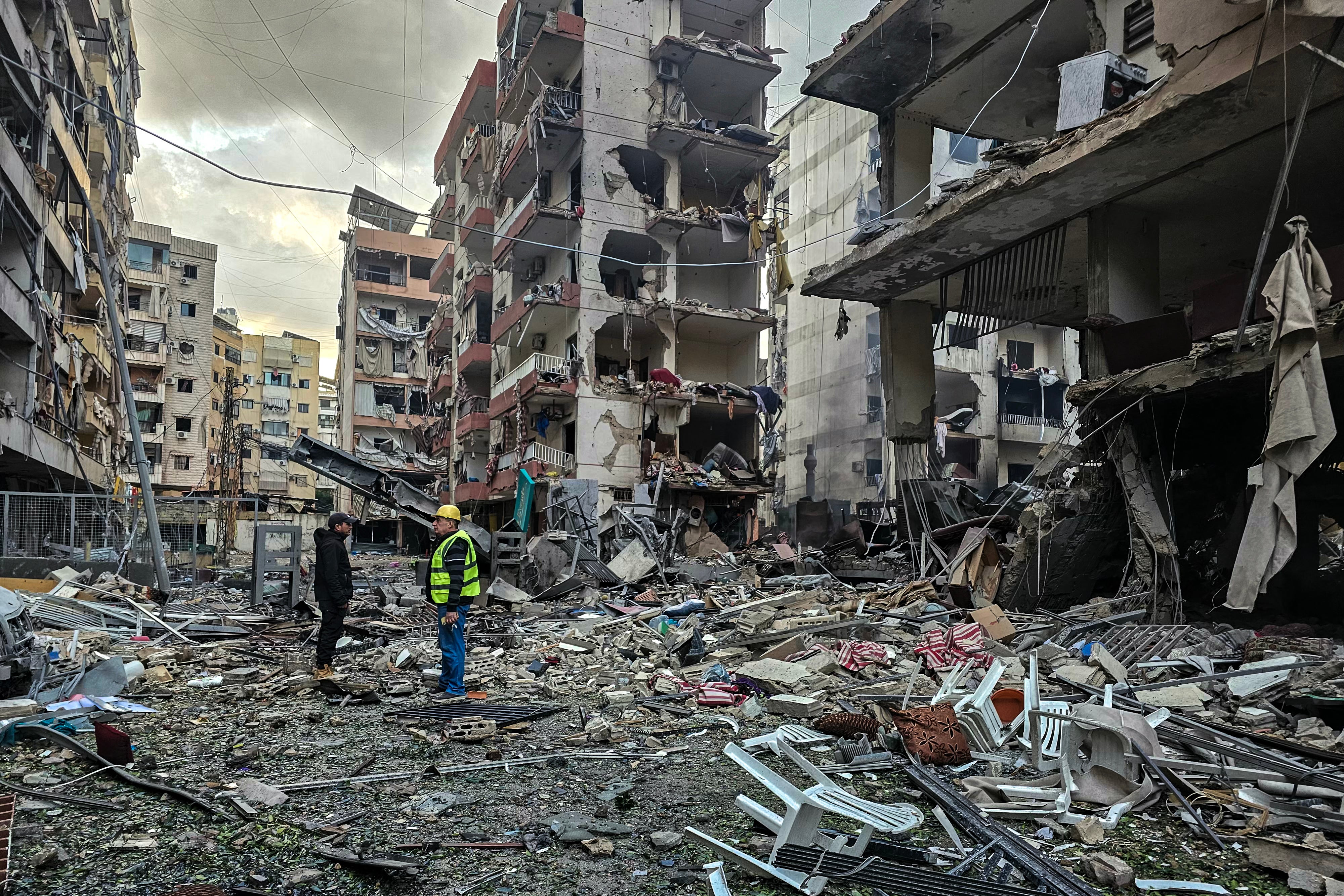 Men inspect a site of overnight Israeli airstrikes in the southern suburbs of Beirut on March 16, 2026.