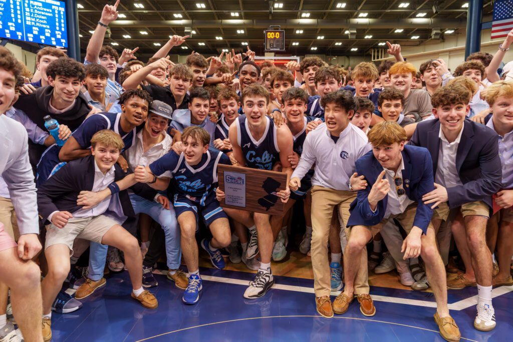 Connor Andree holds the Shore Conference Tournament trophy surrounded by CBA players and students. (Photo: Patrick Olivero) - CBA SCT Champs