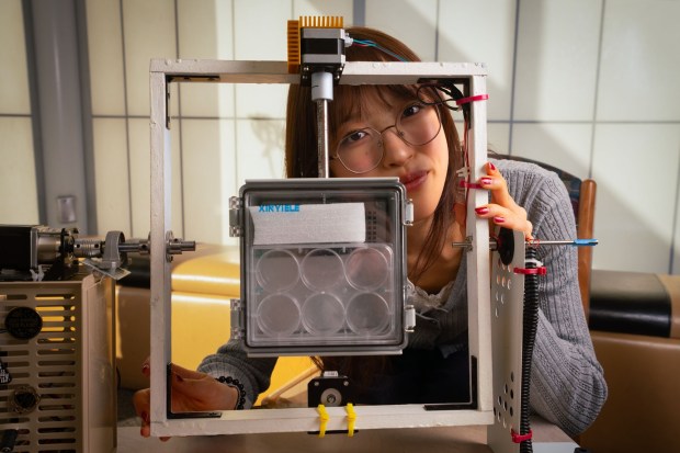 Leanne Fan, a twelfth-grade student at Westview High School and a finalist in the Regeneron Science Talent Search contest, demonstrates the clinosat she made and used to simulate microgravity conditions on earth for future space travel on Thursday, Jan. 29, 2026. (Howard Lipin / For The San Diego Union-Tribune)