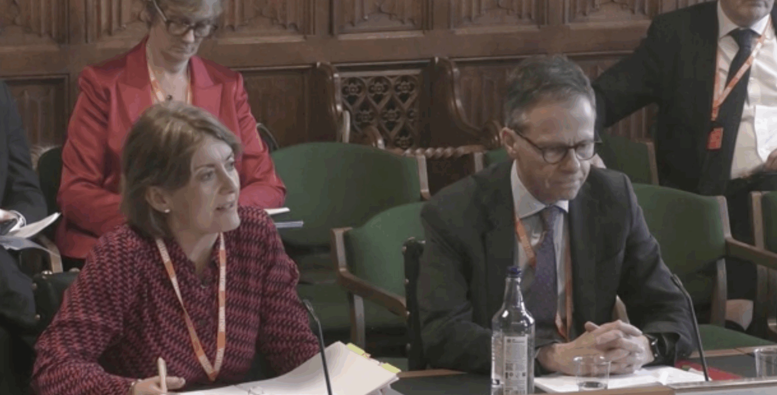 Two people talking during a Parliamentary session