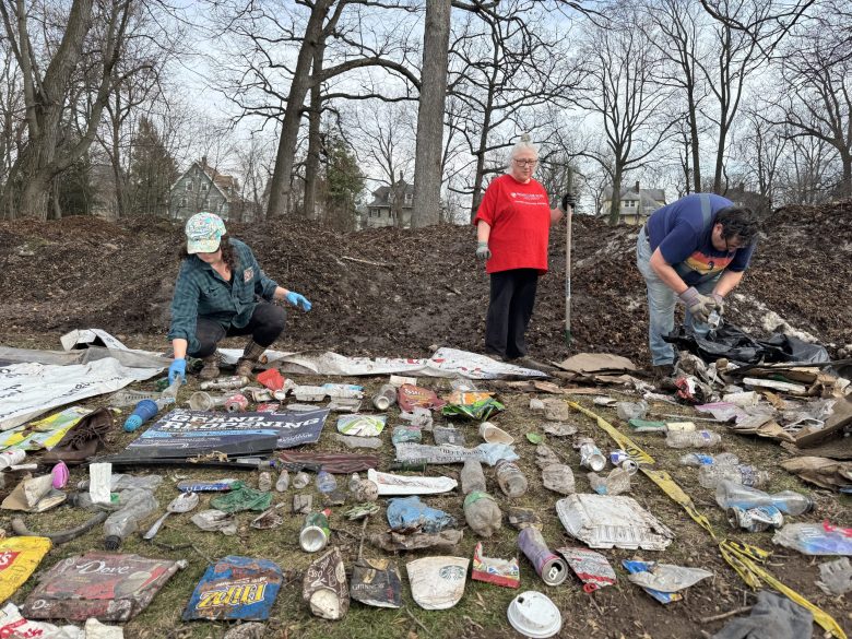 Montclair resident showing trash  pulled from piles of snow at Essex Park
