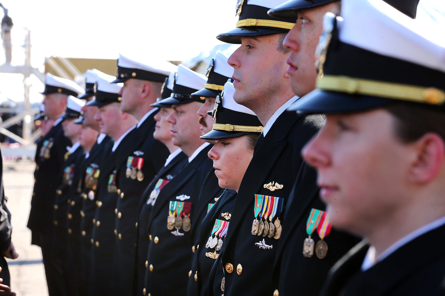  Navy officers, part of the inaugural crews of the USS Massachusetts stood at attention.