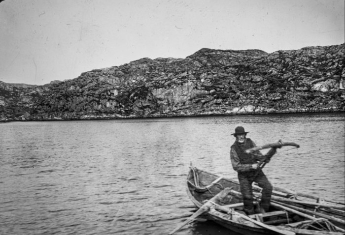 Antique photo of man whaling with a crossbow in Skogsvågen
