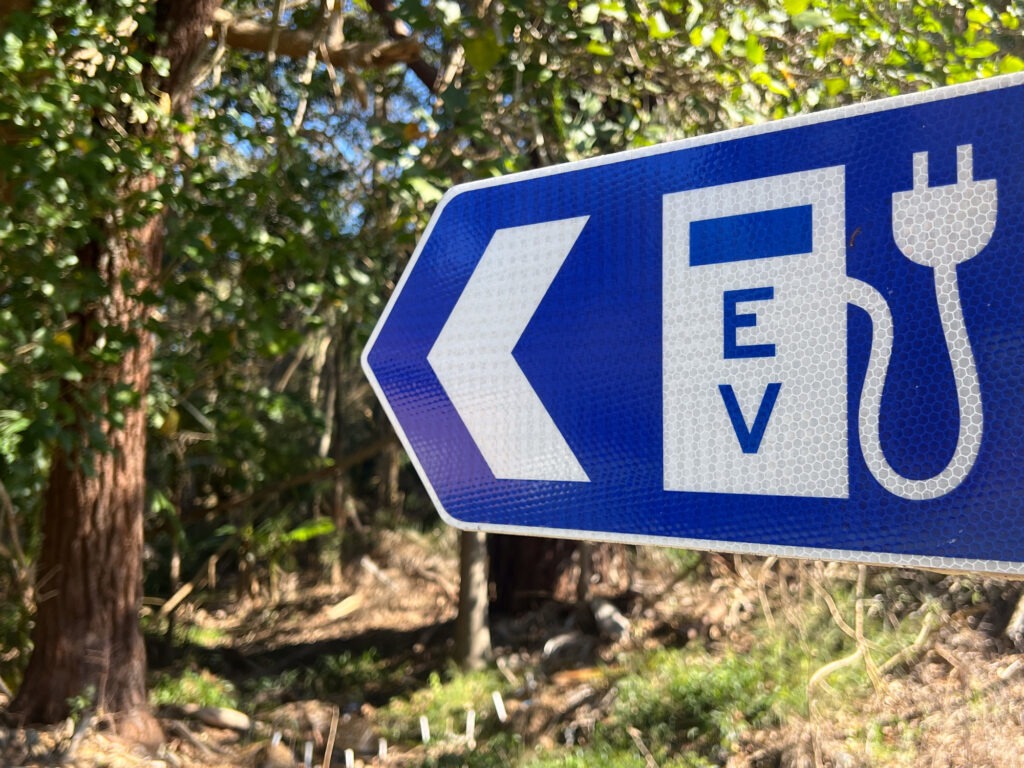 EV charging station traffic sign in a public parkland, Australia.