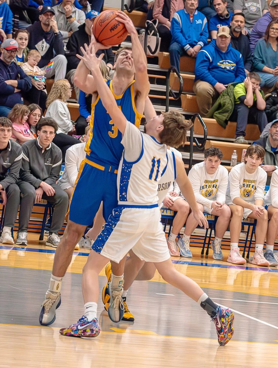 Gavin Albring of Ida has his shot contested by Jefferson's Brayden Burkmier during a 63-52 Ida victory in the finals of the Division 2 Boys Basketball District Tournament at Jefferson on Friday, Feb. 27, 2026.