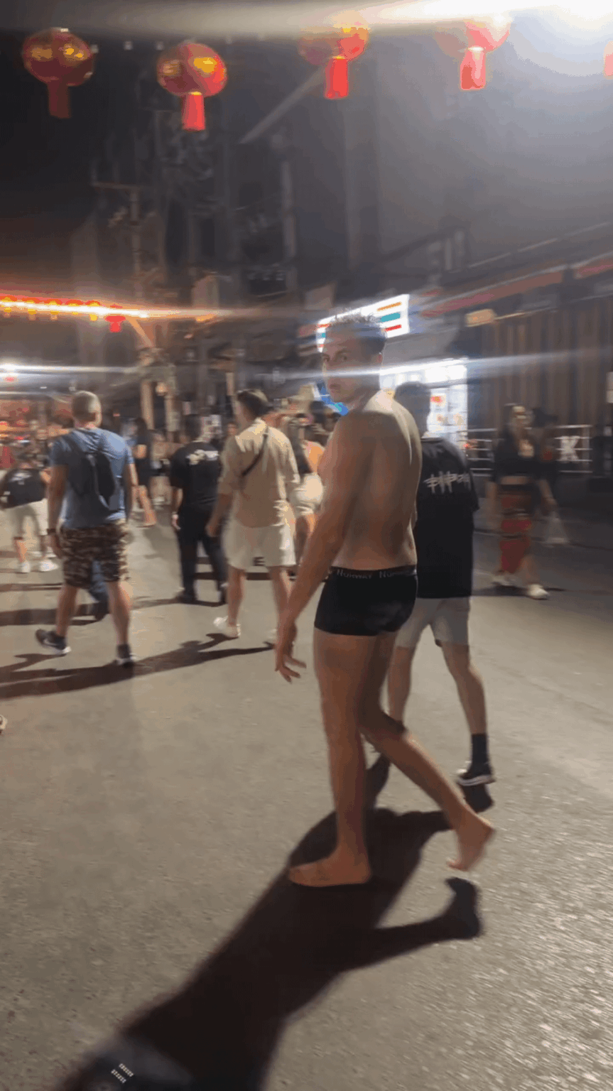 You are a foreigner walking down the street in Thailand
