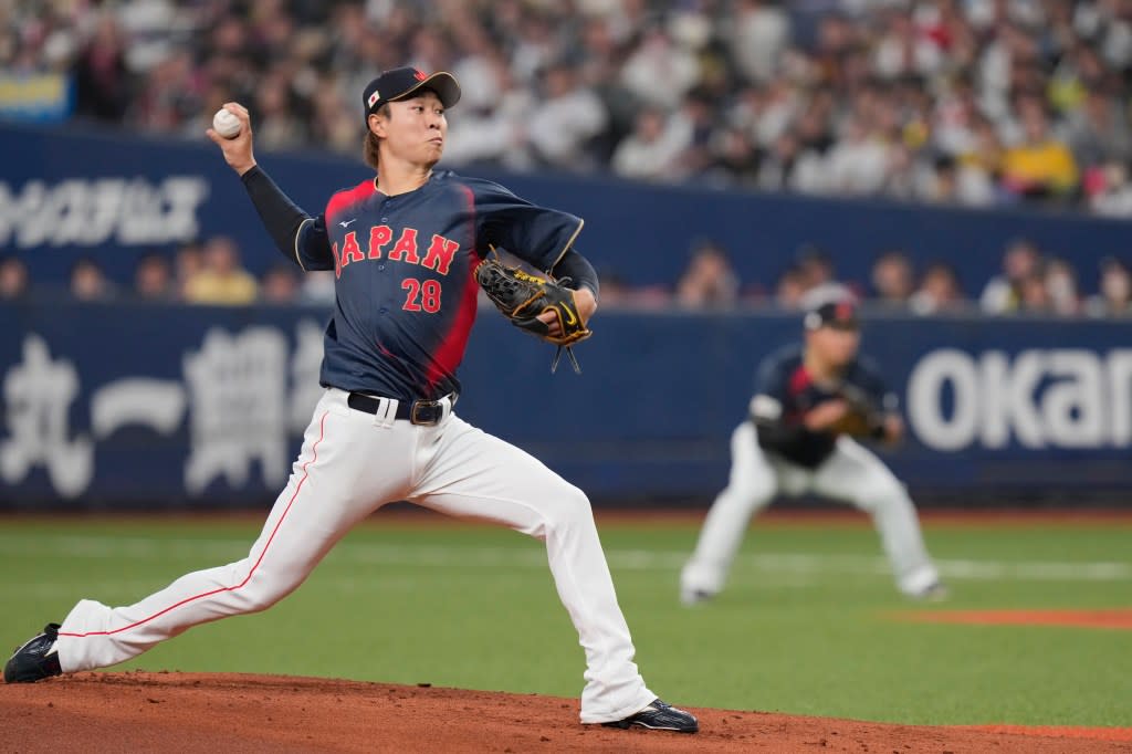 Hiroto Takahashi of Japan throws the ball during the first inning of the exhibition game between Japan national team and Hanshin Tigers prior to the Pool C games at the World Baseball Classic on Tuesday, March 3, 2026 in Osaka, western Japan. AP