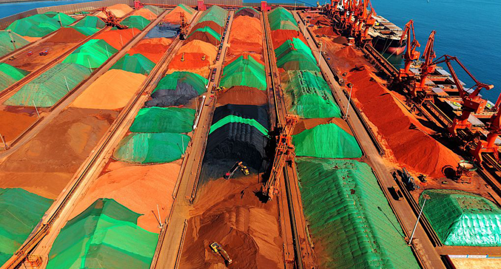 China move prompts budget warning over 'bedrock' of Australian economy as iron ore stockpiles grow