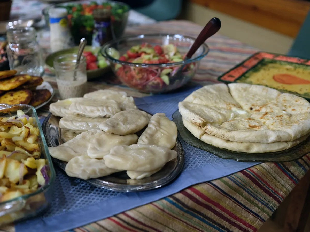 Georgian food at an early Georgian-American Thanksgiving meal. Left, khinkali (a type of dumpling); right, khachapuri
