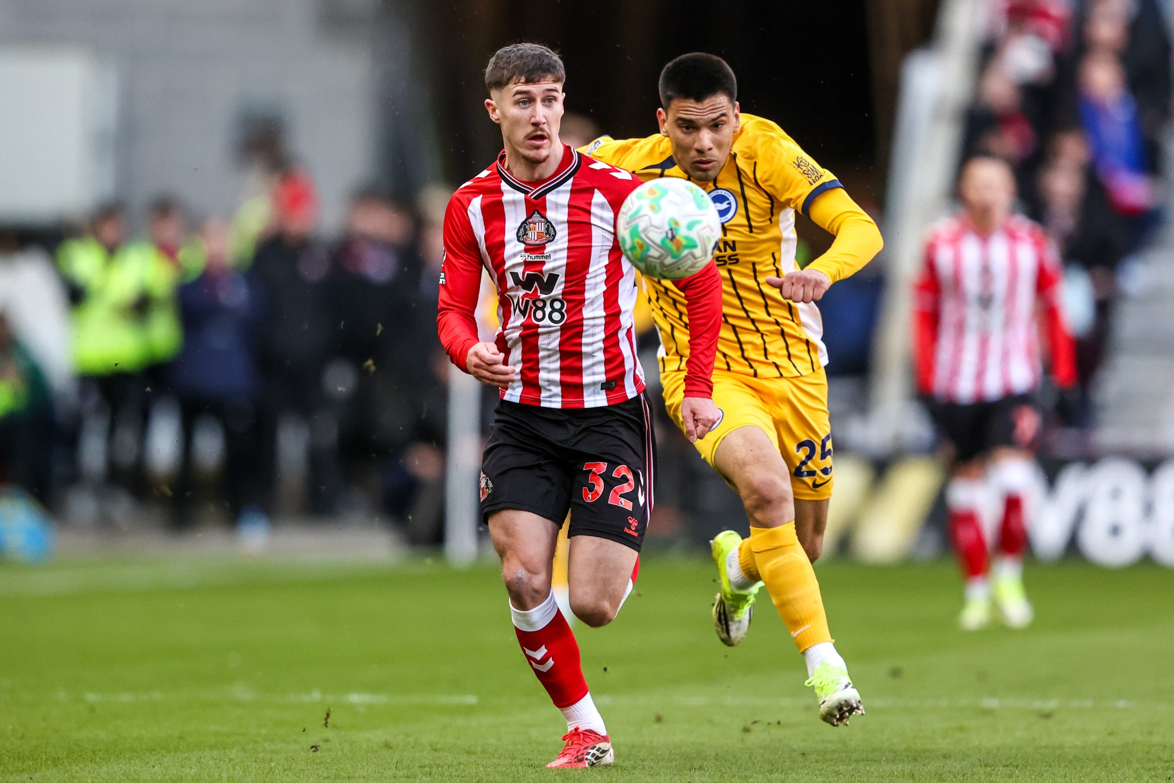 Trai Hume of Sunderland breaks with the ball, closely tracked by Diego Gomez of Brighton & Hove Albion, during the Premier League match between Sunderland and Brighton & Hove Albion at Stadium of Light in Sunderland, United Kingdom, on March 14, 2026. (Photo by Alfie Cosgrove/News Images/NurPhoto via Getty Images)