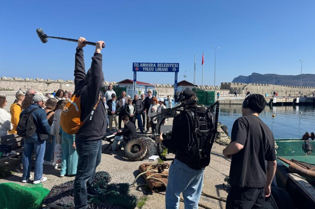 A film crew records a scene at Amasra Passenger Port as locals gather to watch the shooting of a Russian drama film in Bartin, Türkiye. (AA Photo)