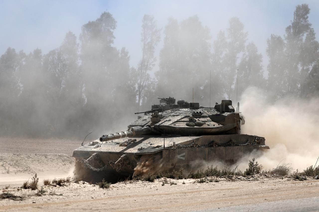An Israeli Merkava tank manoeuvres towards the southern border of the Gaza Strip near Khan Younis, seen from southern Israel, on 20 May 2025.