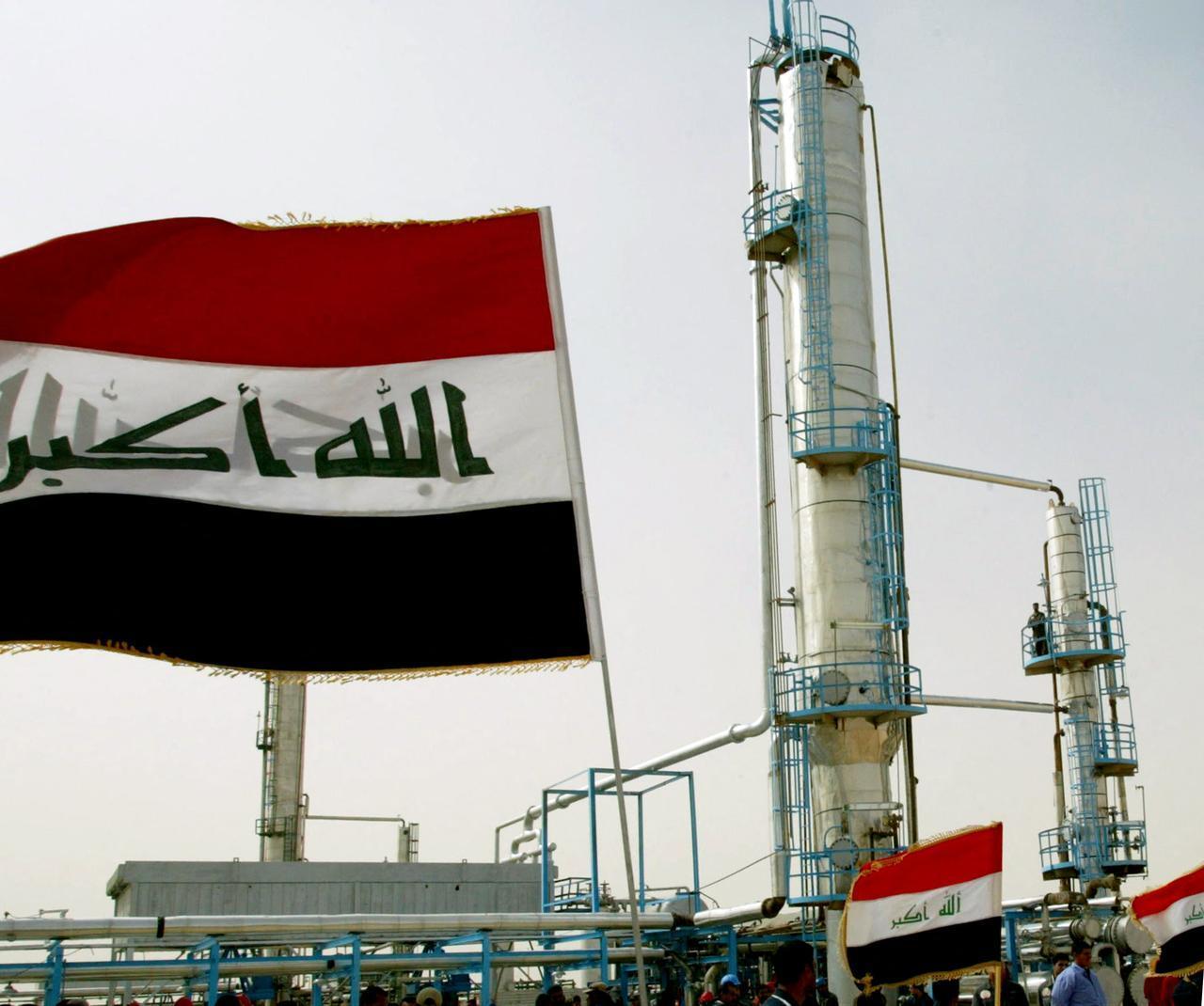 Iraqi flags flutter during the opening ceremony of a new oil refinery plant in the Shiite holy city of Najaf, central Iraq, on March 15, 2008. (AFP Photo)