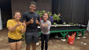 students in front of an aquaponics grow bed