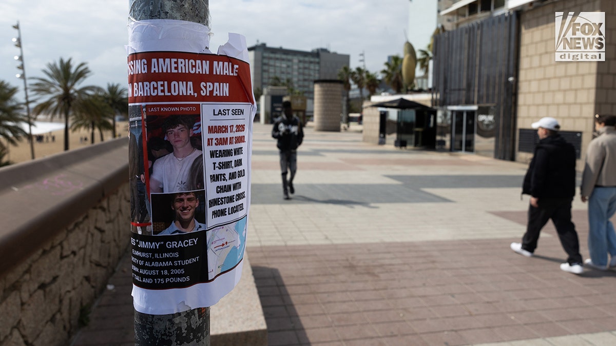 A missing person flyer for Alabama student James Gracey posted along a shoreline and marina.