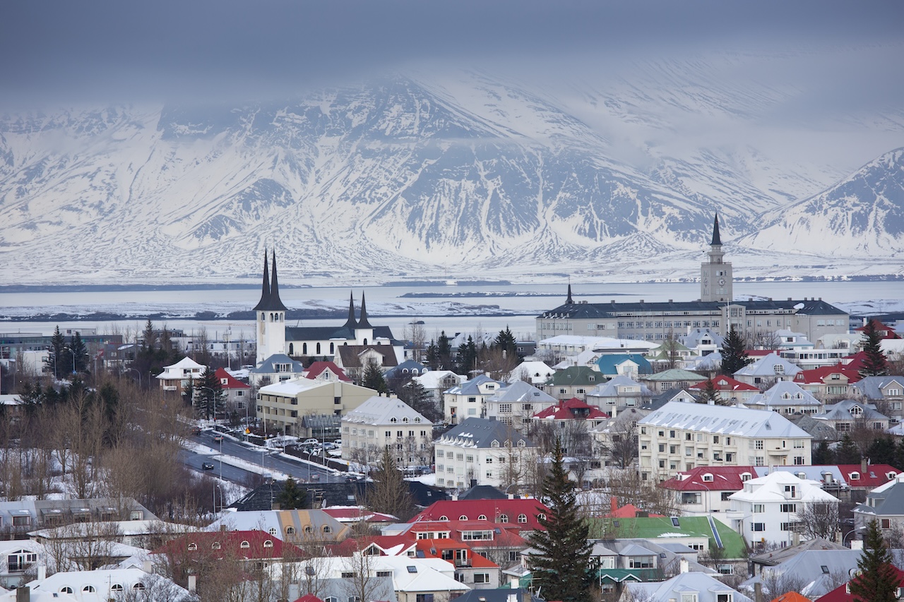 REYKJAVIK, SOUTH ICELAND: The capital city of Reykjavik with traditional bright coloured rooves and snow-covered glacier mountains, Iceland. (Photo by Tim Graham/Getty Images)