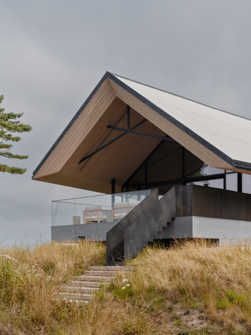 grass-covered seaside family home repurposes abandoned soviet military bunkers in latvia - 2