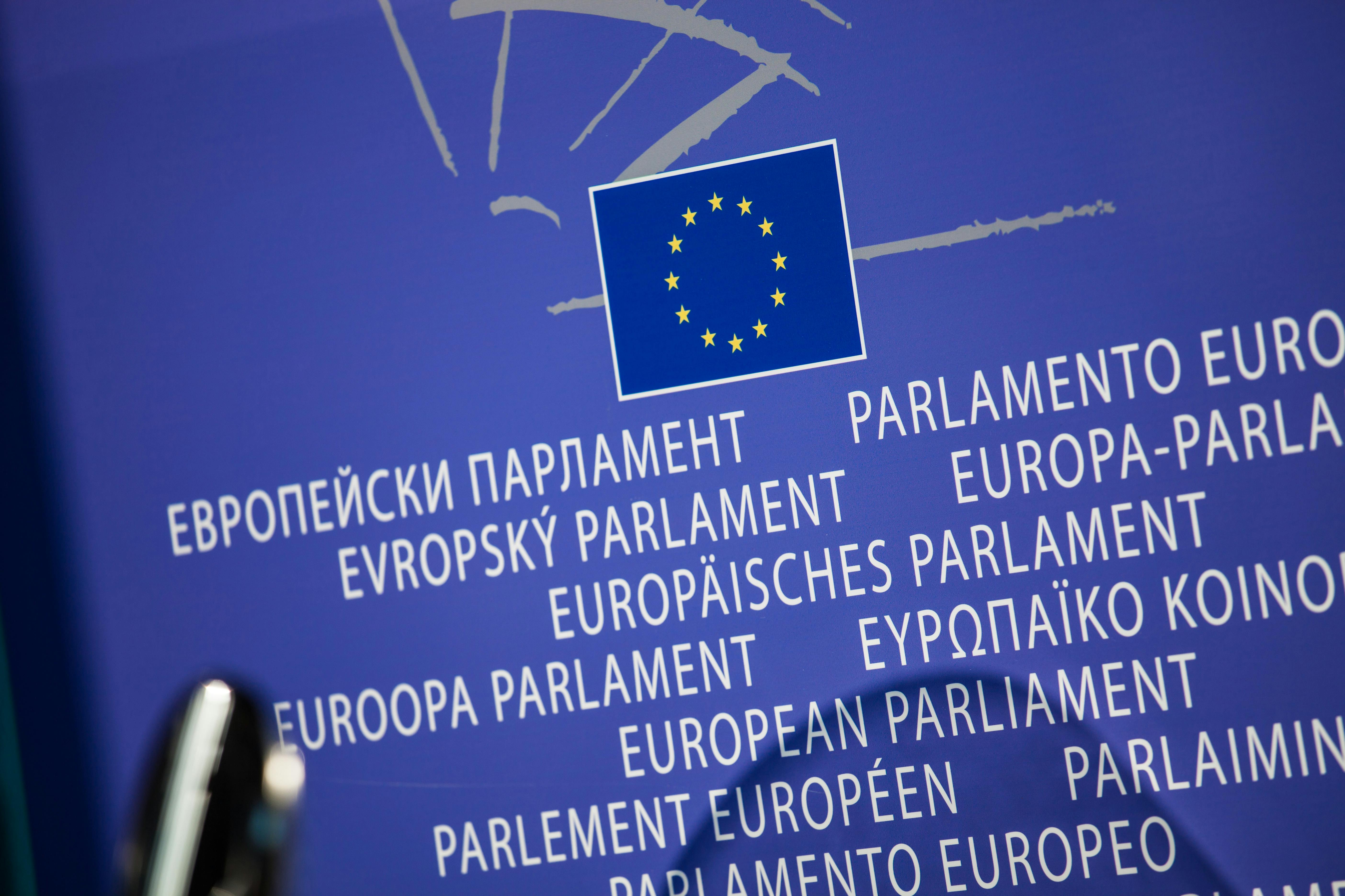 European Parliament logo with EU flag and the words “European Parliament” displayed in multiple languages on a blue background.