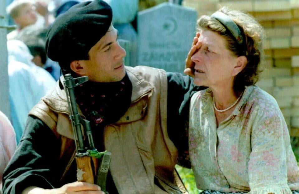 Soldier of the ARBiH, Galib Muratović-Gale, ready to go to the line, wipes his mother's tears in front of the grave in Rahić, April 28, 1993.