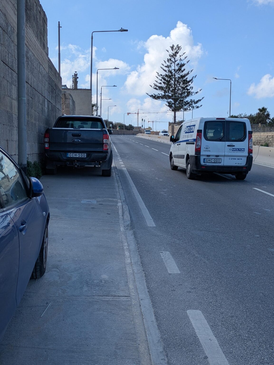 Who do I report a car blocking the entire pavement to? Would they actually care to fine or tow? I don't like walking into busy roads