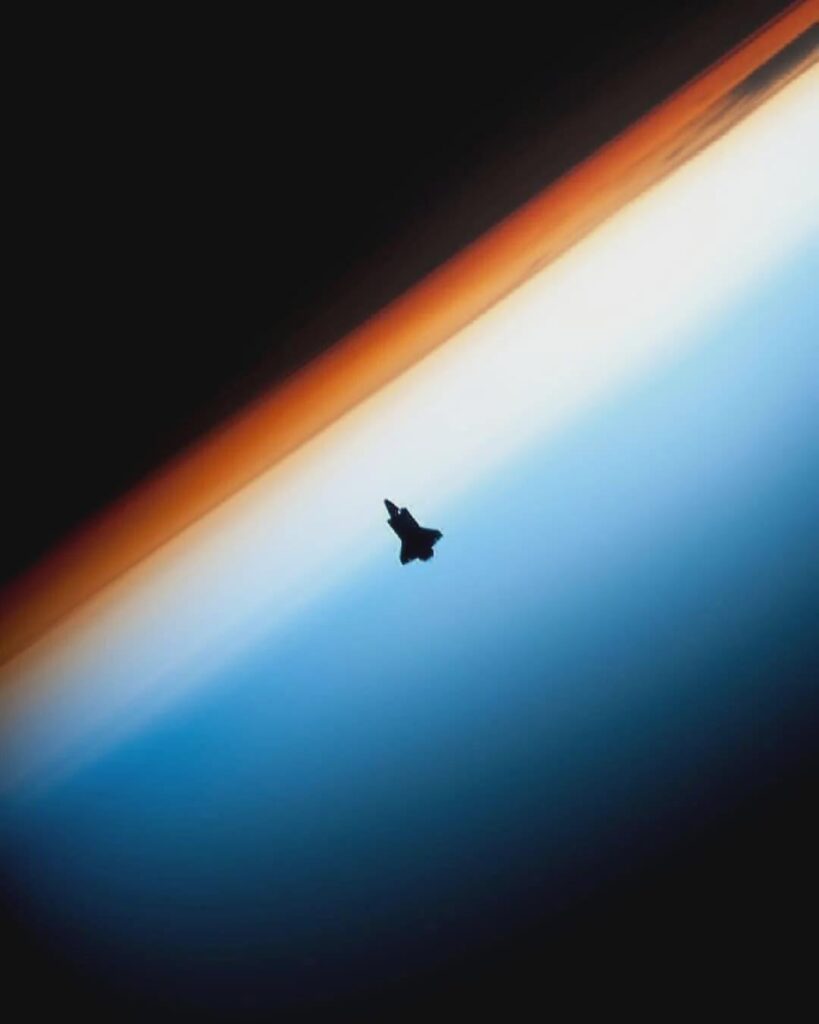 space shuttle endeavour silhouetted against earth’s horizon as it approaches the international space station for docking during the sts-130 mission. 
photographed from orbit by an expedition 22 crew member.