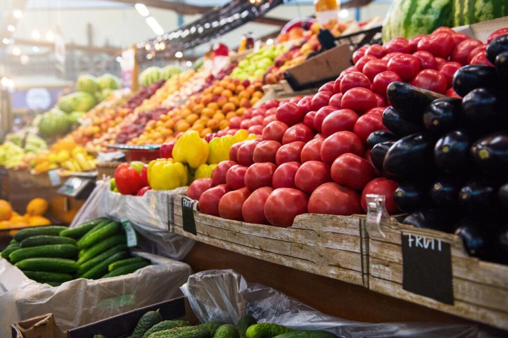 Fresh organic vegetables displayed at a market counter in a grocery store. (Adobe Stock Photo)