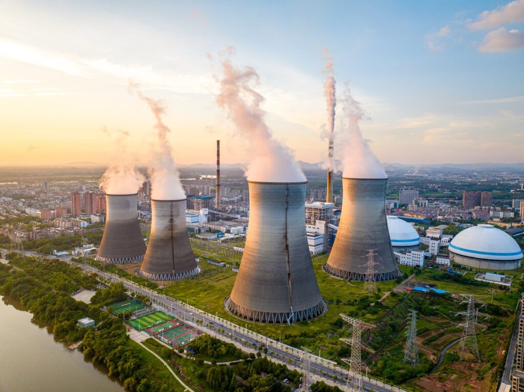 The Best 3 Nuclear Energy Stocks to Buy and Hold for Decades Several cooling towers outside an energy facility.