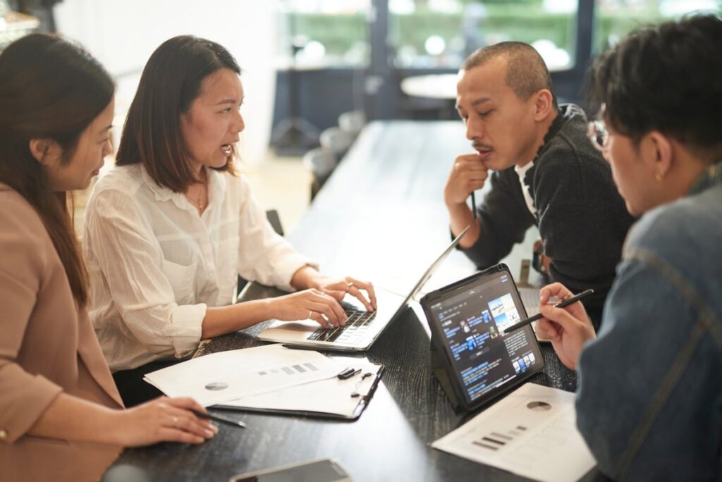 Prediction: This Artificial Intelligence (AI) Stock Will Benefit Most From the Shift to Software Monetization in 2026 Professionals in an office meeting.