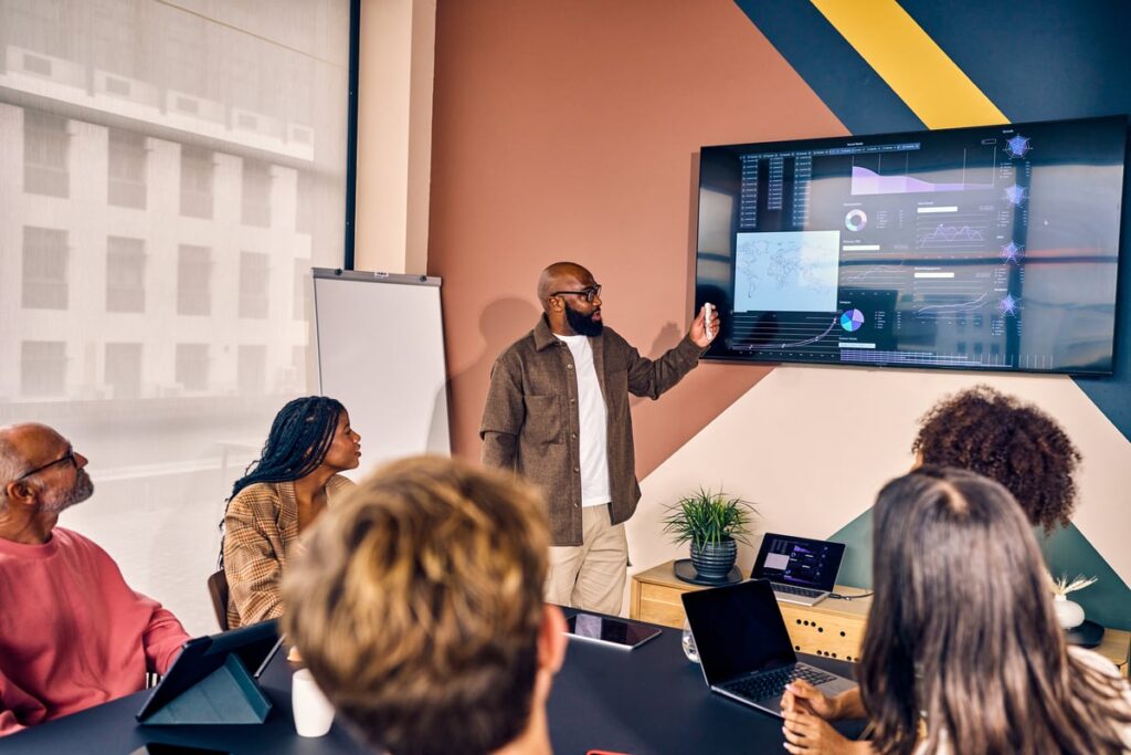 The Artificial Intelligence (AI) Stock That Could Redefine Its Industry by the End of 2026 Professional explaining a presentation in an office meeting.