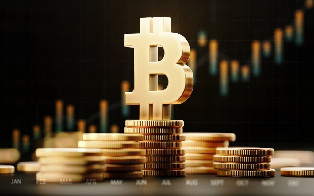 Bitcoin logo on top of gold coins with candle chart in background.