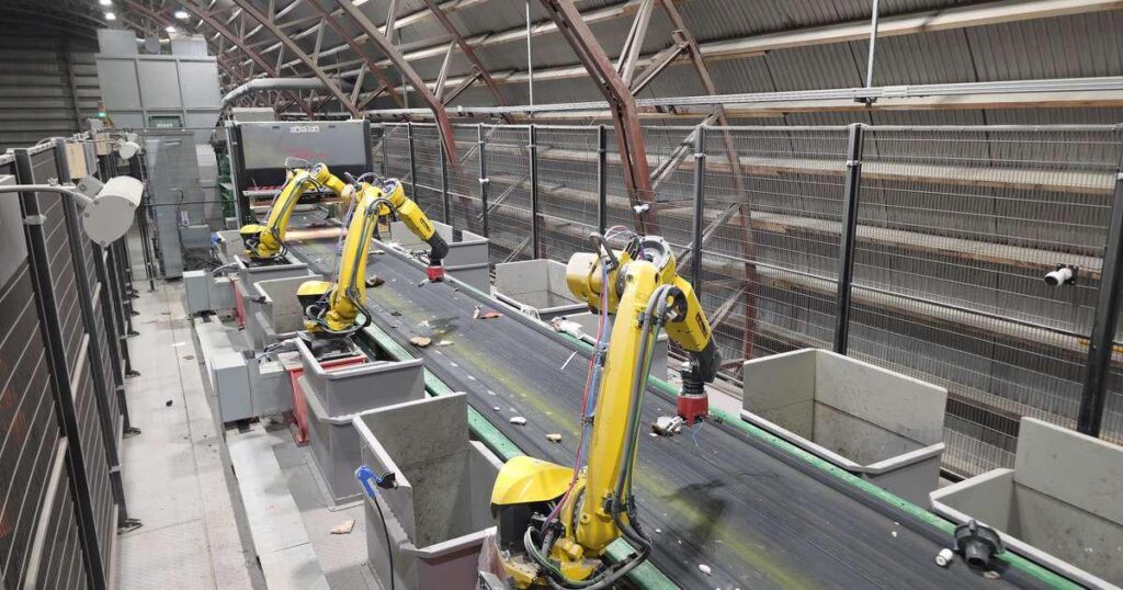 Three robots conscientiously sort trash Three robots conscientiously sort trash