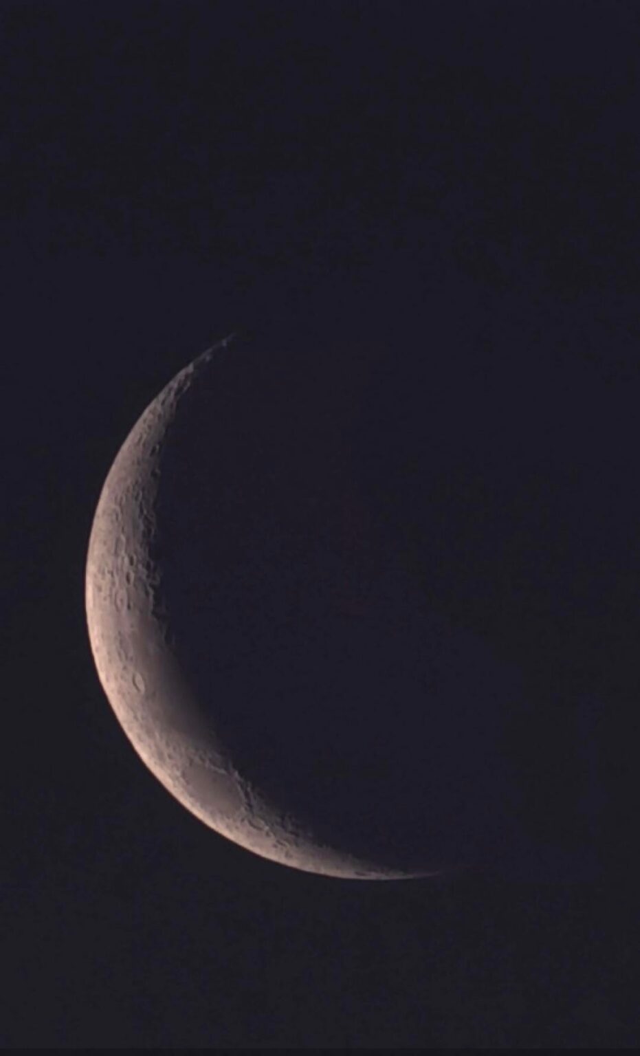 The waxing crescent moon before sunset.