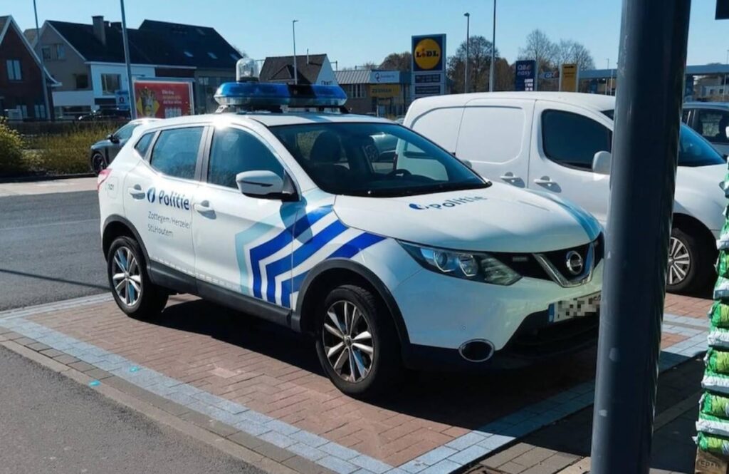 Officer parks a service car in a disabled space during a visit to Lidl in Zottegem