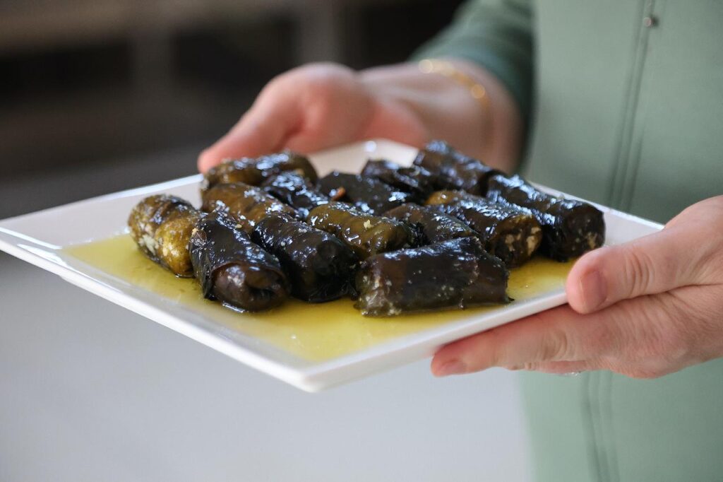 Lor dolmasi, a traditional dish made by wrapping a filling of lor cheese and bulgur in evelik leaves, is served with melted butter in Bayburt, Türkiye, March 14, 2026. (AA Photo)