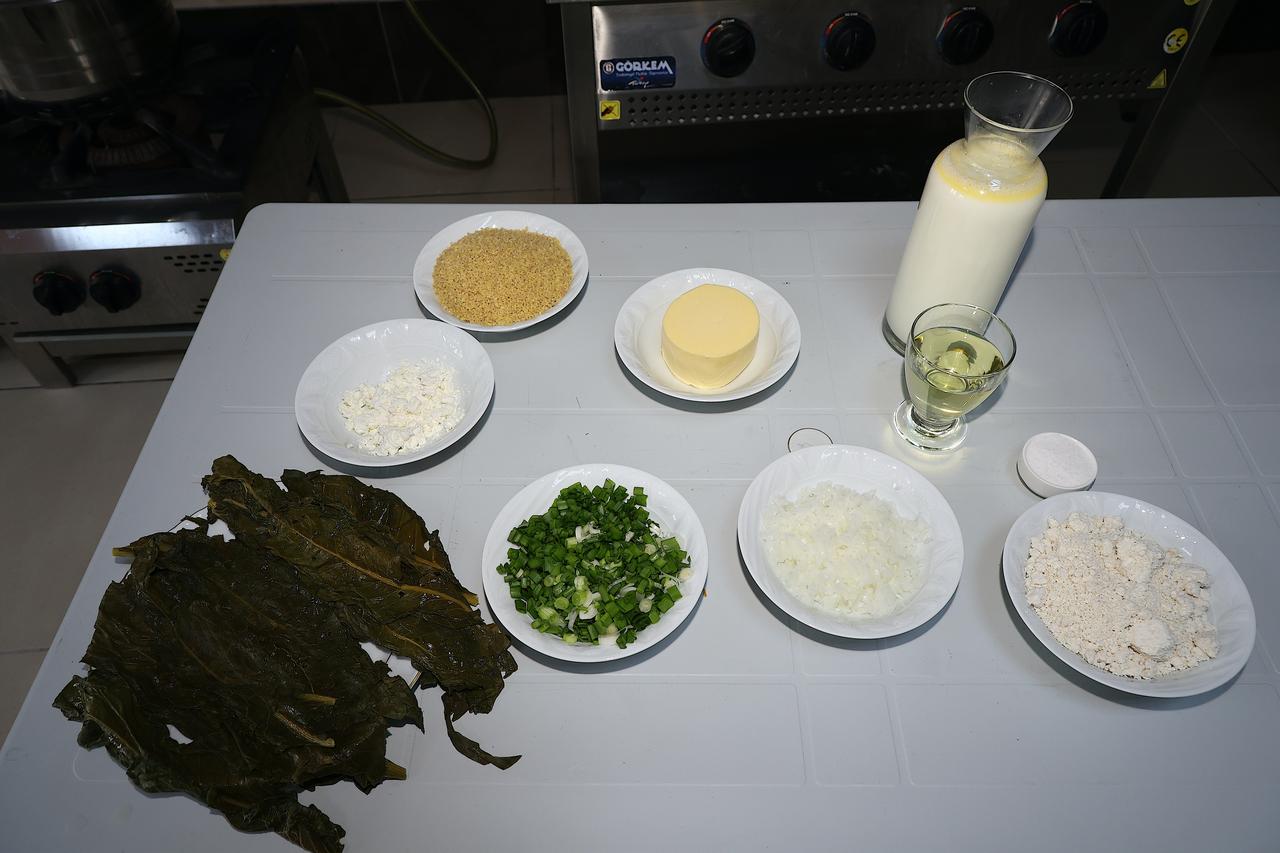 Ingredients used to prepare lor dolmasi, including evelik leaves, lor cheese, bulgur, butter, milk and chopped onions, are displayed in Bayburt, Türkiye, March 14, 2026. (AA Photo)