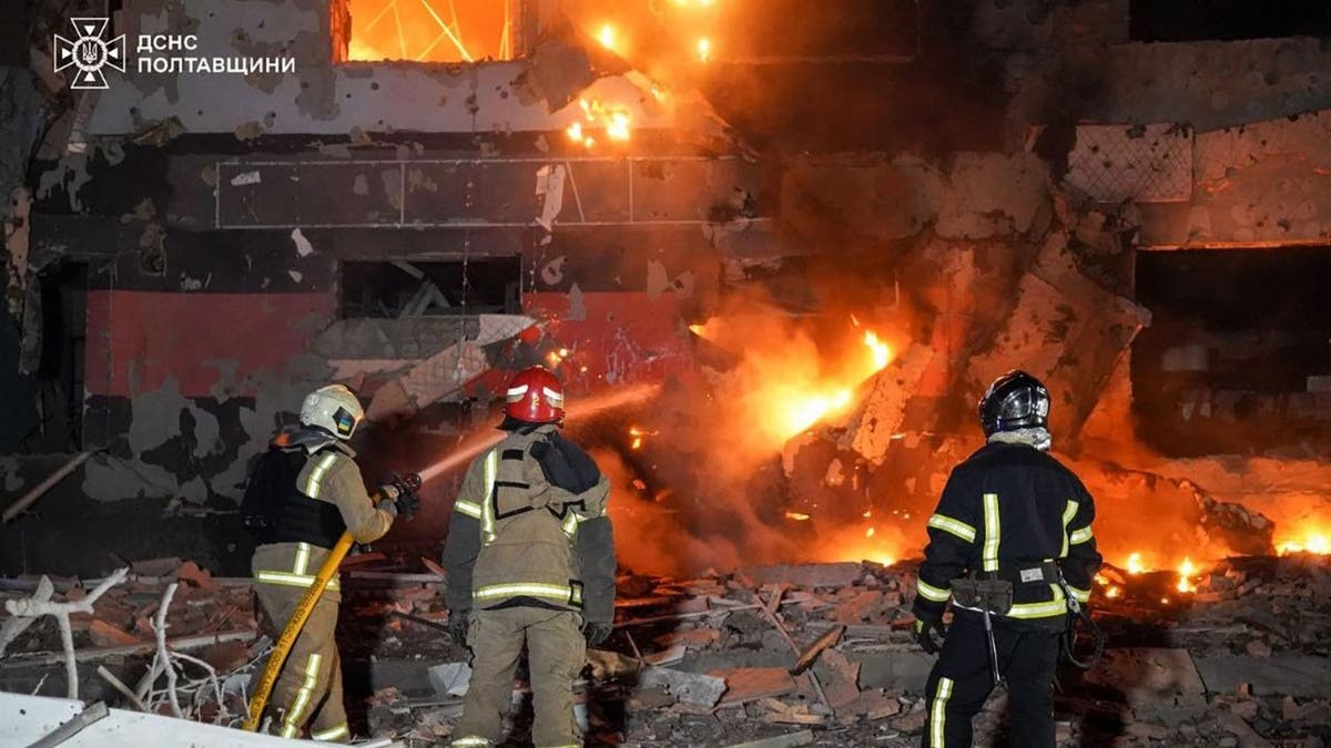 Firefighters battle blaze at apartment building hit by Russian drone