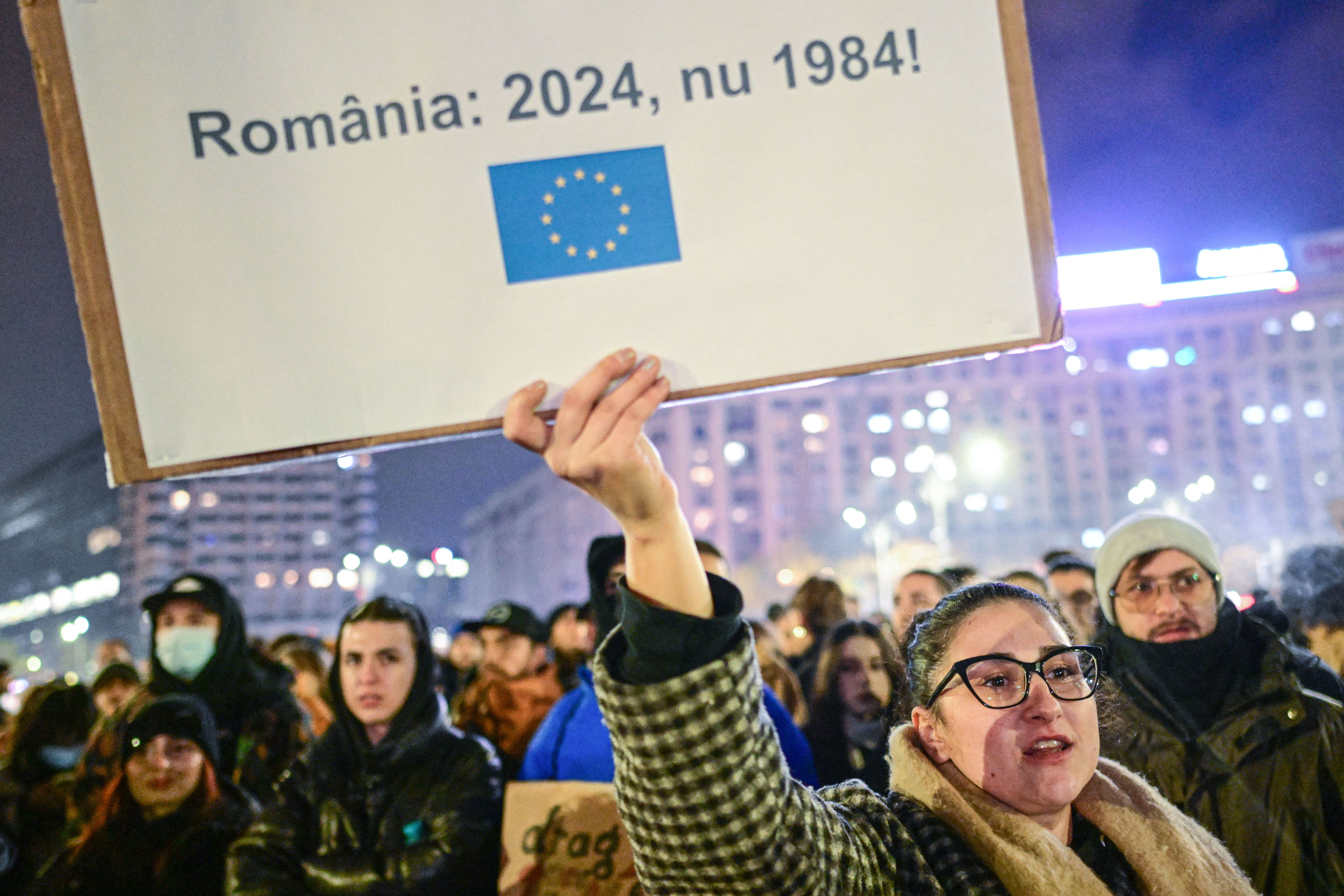 A protester is holding up a placard