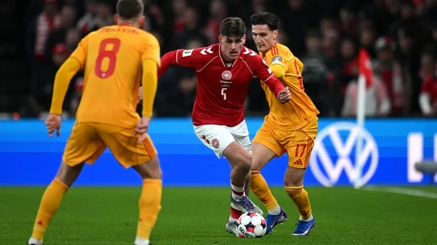 Joakim Maehle of Denmark runs with the ball while under pressure from Lirim Qamili of North Macedonia during the FIFA World Cup 2026 European Qualifiers KO play-offs match between Denmark and North Macedonia at Parken Stadium on March 26, 2026 in Copenhagen, Denmark. (Photo by Patrik Lundin - UEFA/U