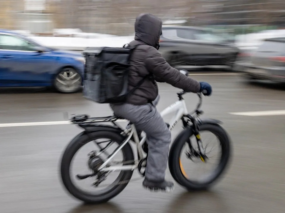 A courier on an e-bike.