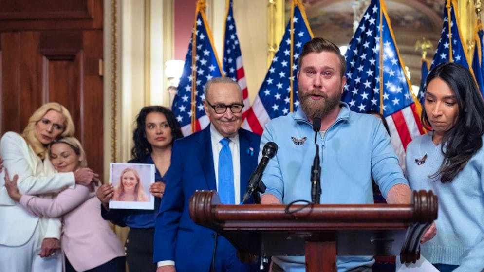 ARCHIVE - Sky Roberts, the brother of Virginia Giuffre, speaks with his wife Amanda (r) as Senate Minority Leader Chuck Schumer, D-N.Y., listens and survivors of convicted sex offender Jeffrey Epstein and lawmakers gather. Photo by J. Scott Applewhite/AP/dpa