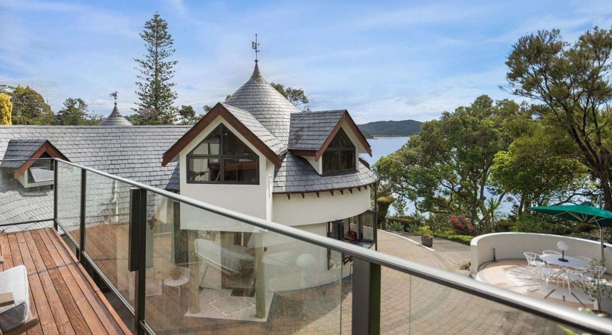 Curved tower with turret roof at House in New Zealand in the Bay of Islands for sale design based on Castell Coch and called Castell Bach with agent Mackys Real Estate part of Bayleys Realty Group for over $3m New Zealand dollars
