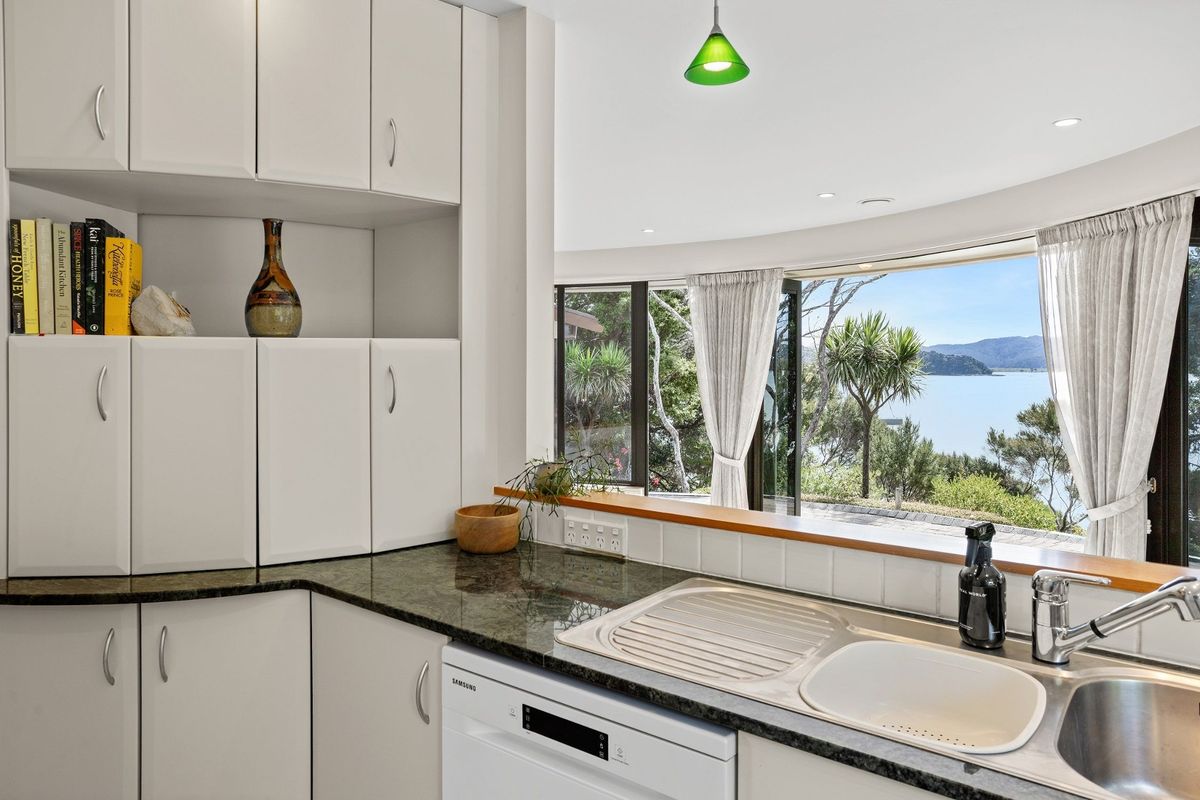 Curves are king of the castle - windows, walls, and the kitchen units at a House in New Zealand in the Bay of Islands for sale design based on Castell Coch and called Castell Bach with agent Mackys Real Estate part of Bayleys Realty Group for over $3m New Zealand dollars