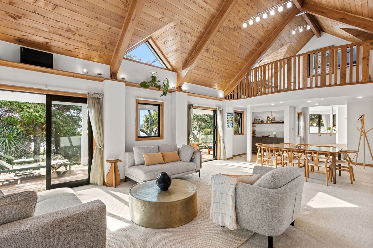 The 'great hall' was added in 2008 double-height space with exposed wooden ceiling and beams used as lounge and dining at a House in New Zealand in the Bay of Islands for sale design based on Castell Coch and called Castell Bach with agent Mackys Real Estate part of Bayleys Realty Group for over $3m New Zealand dollars