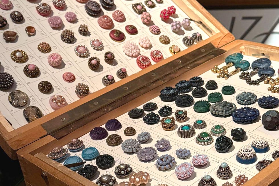 Collection of colorful decorative buttons in a display box.
