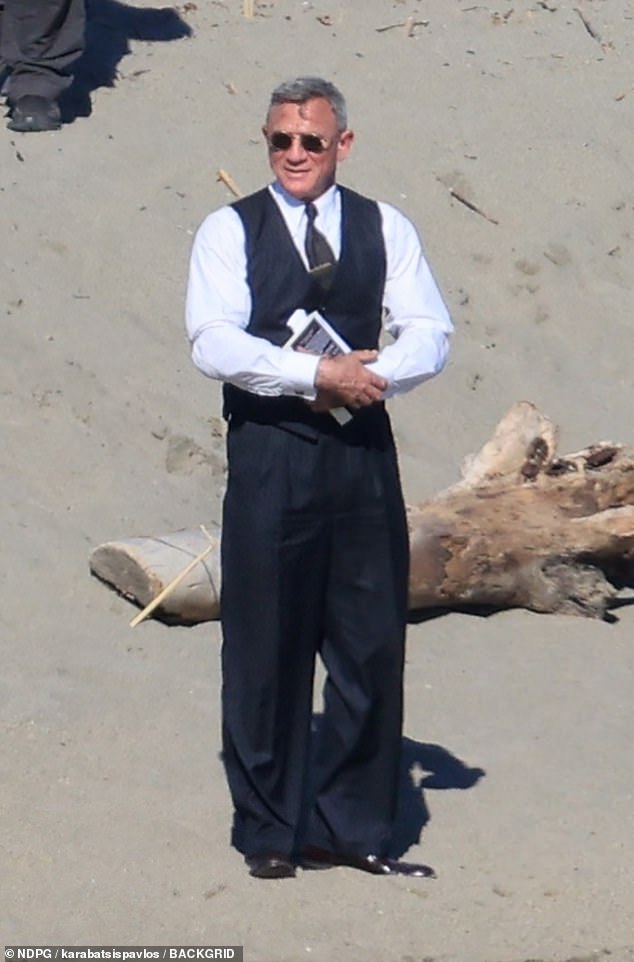 Nearby, Daniel cut a contrasting figure as he was smartly dressed in a white shirt with a navy pinstripe suit