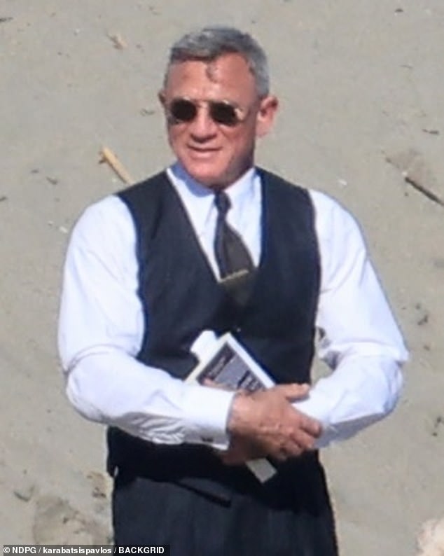 Daniel added a pair of shades as he kept it smart in his suit despite the beach setting