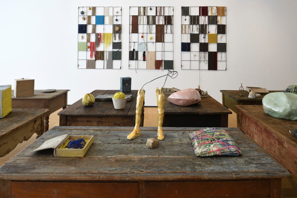 wooden tables featured in an art gallery of sculptures and paintings