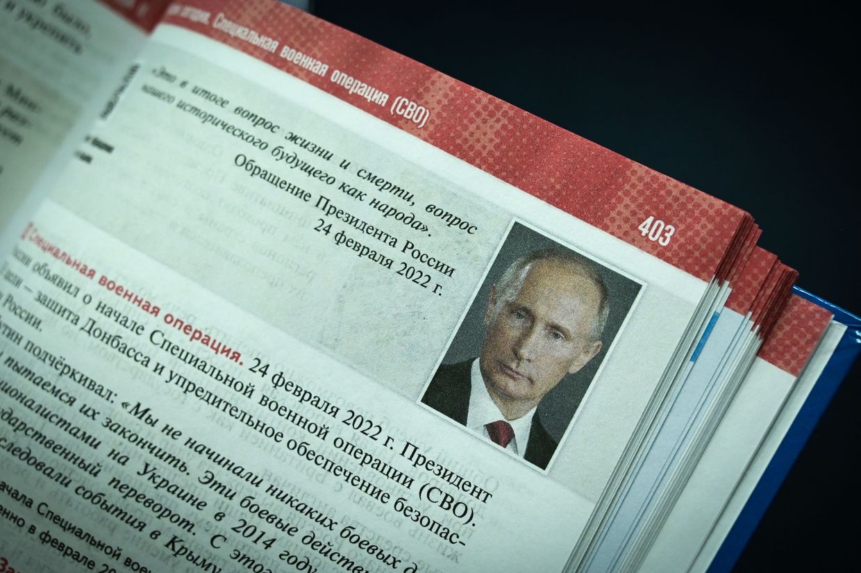 A portrait of Russia’s President Vladimir Putin is seen on a page of a schoolbook for high school students on world history and Russian history in Moscow, Russia, on Aug. 7, 2023.