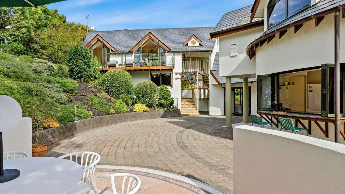 Inner courtyard, external staircase at House in New Zealand in the Bay of Islands for sale design based on Castell Coch and called Castell Bach with agent Mackys Real Estate part of Bayleys Realty Group for over $3m New Zealand dollars